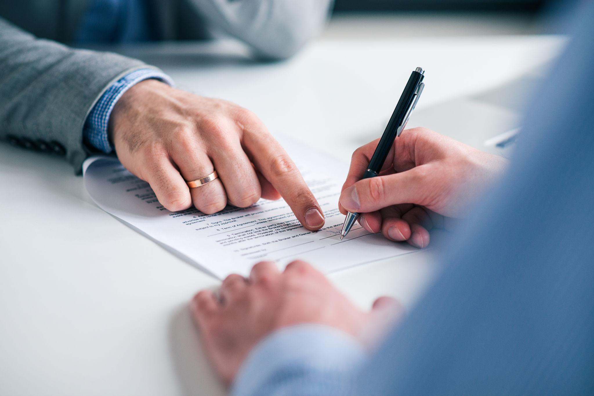 Business professional signing an agreement
